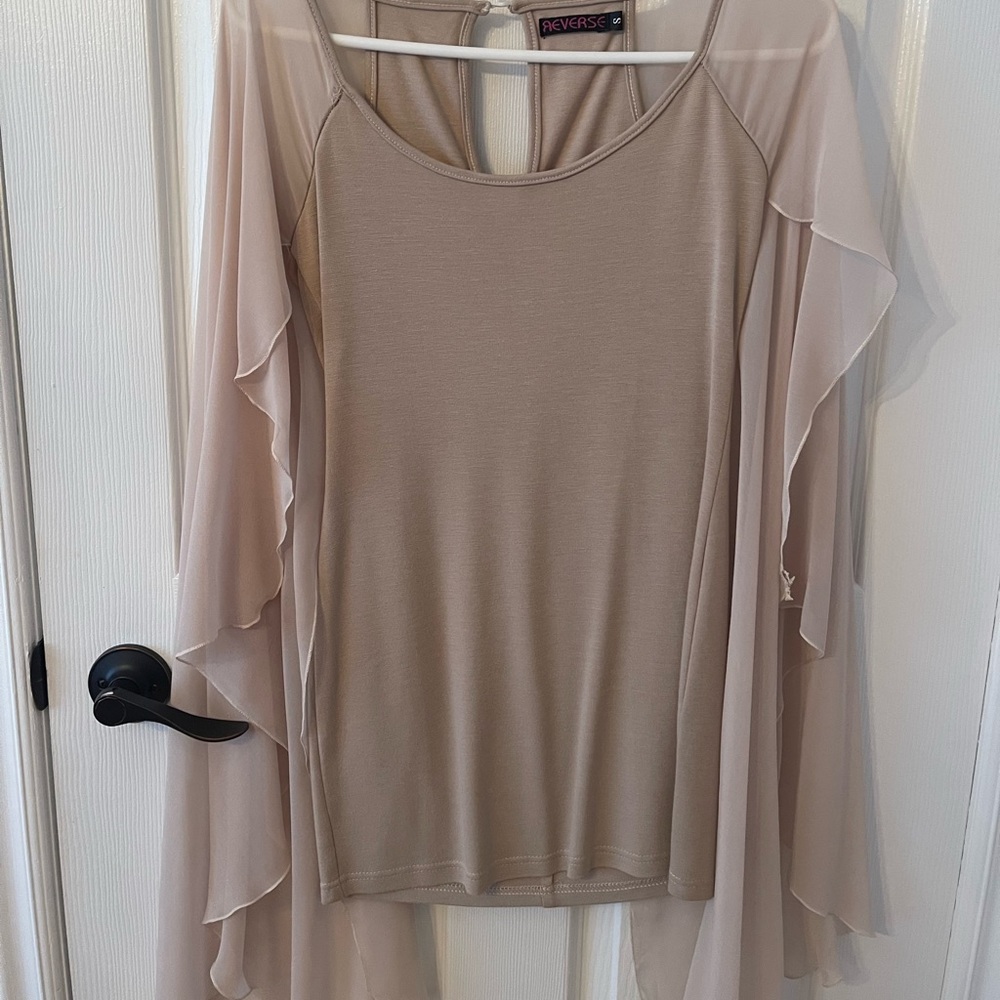 Beige dress with see through sleeves.